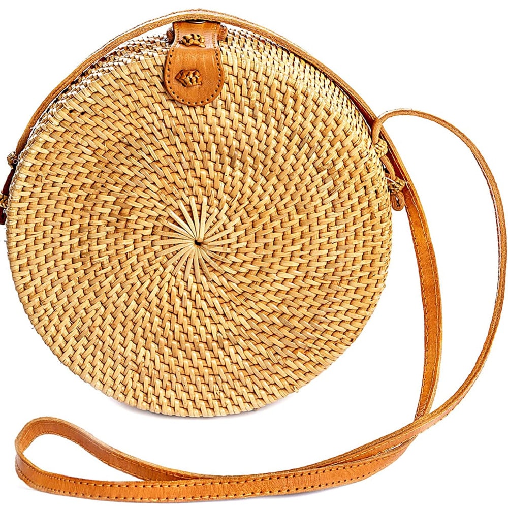 Round rattan crossbody bag with a brown leather strap