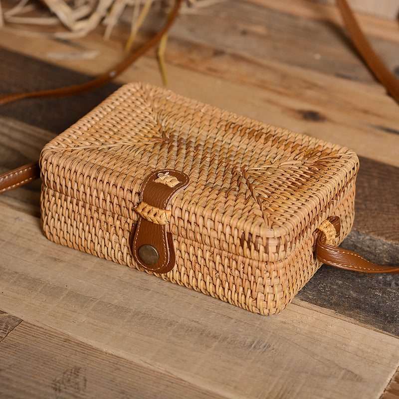 Compact rectangular hand-braided rattan bag – shown in a room setting