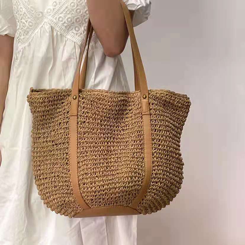 Handwoven straw handbag – worn by a model