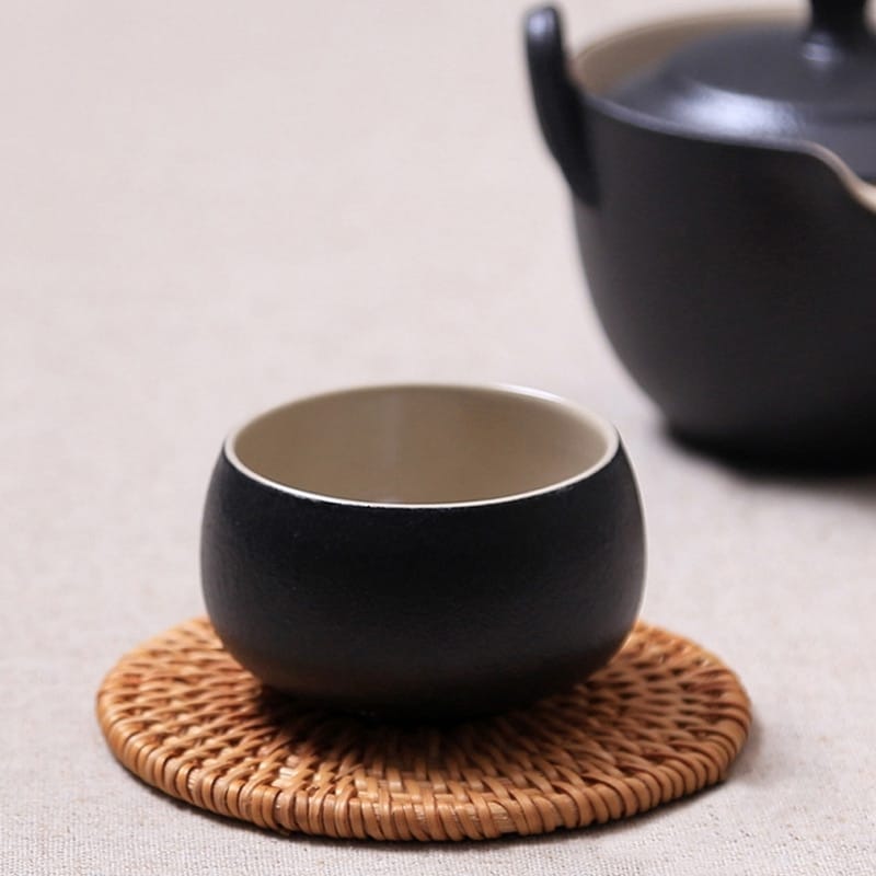 Set of six handwoven rattan drink coasters – shown in a room setting