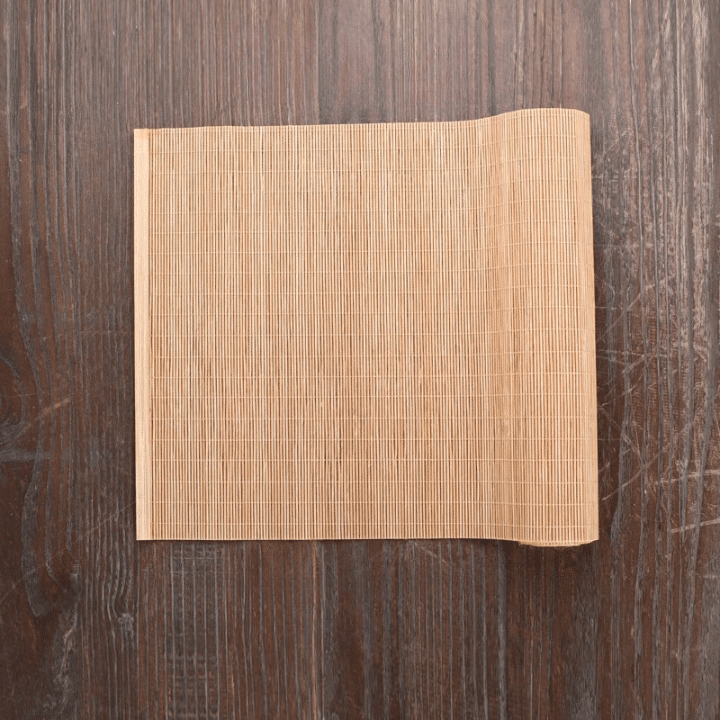 Rectangular natural bamboo placemat in a honey tone