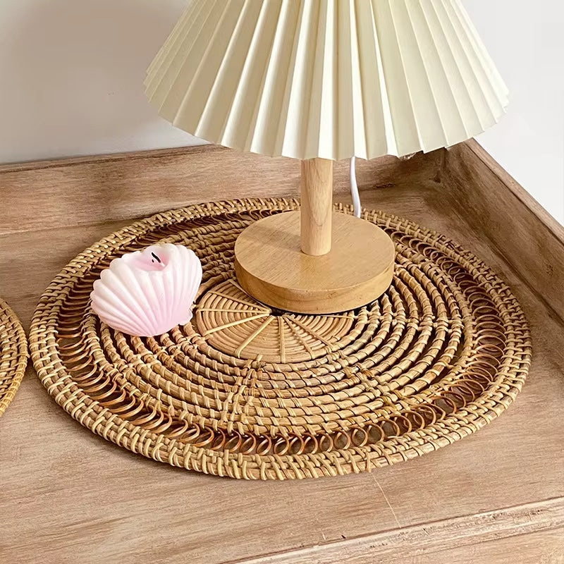 Round straw-look placemat with a radiating sun design – shown in a room setting