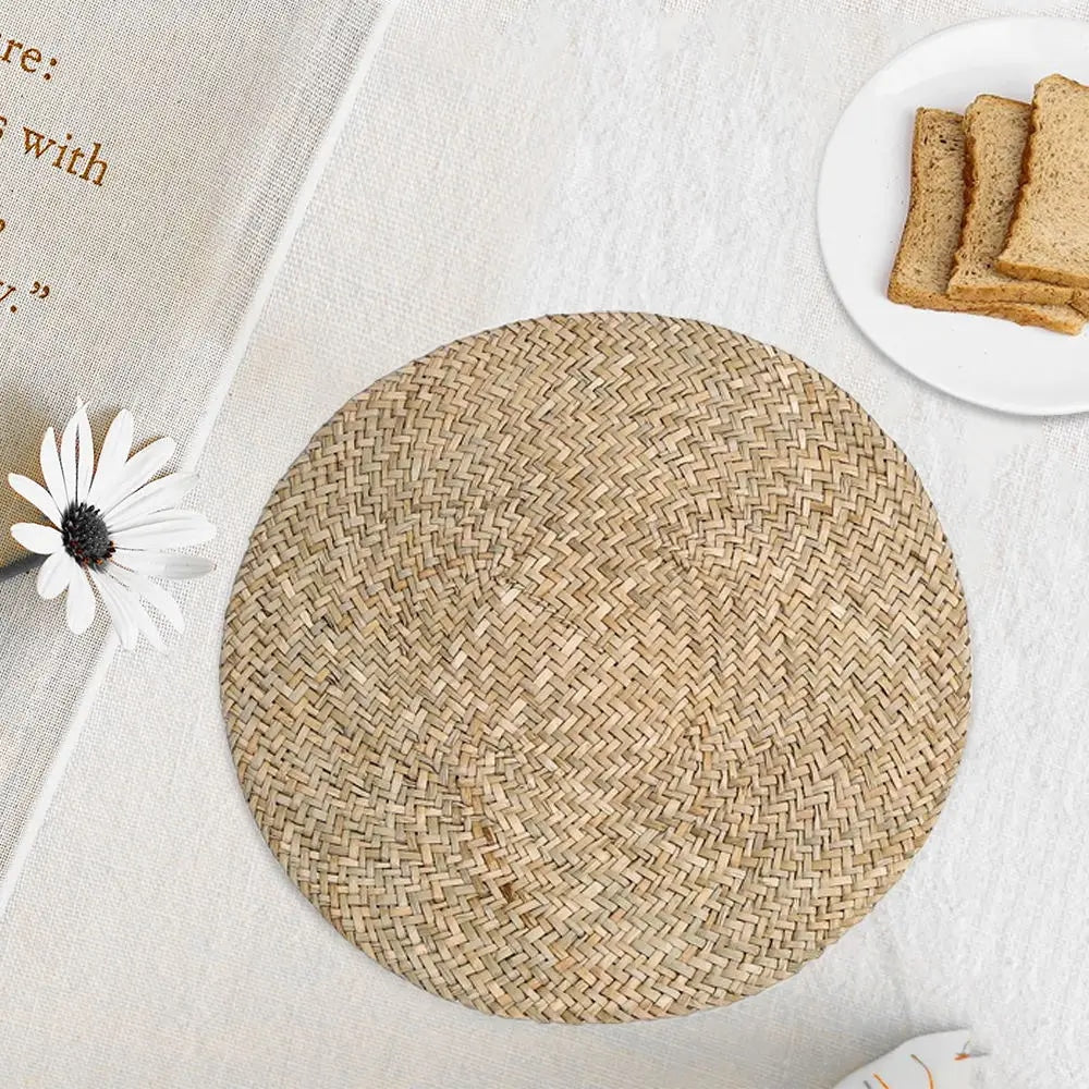 Round handwoven natural straw placemat with a spiral weave