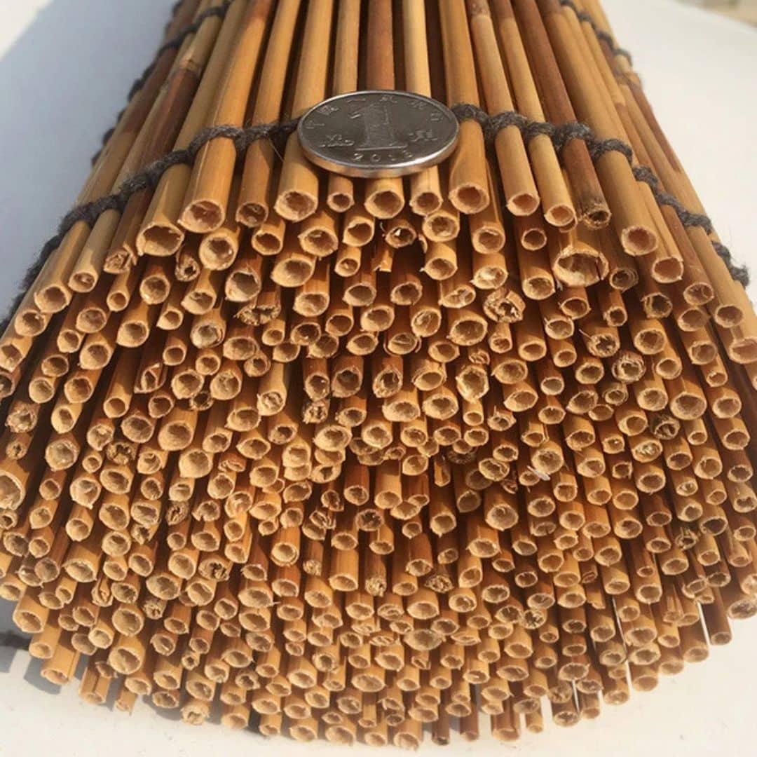Handwoven bamboo roller shade with golden slats – close-up detail