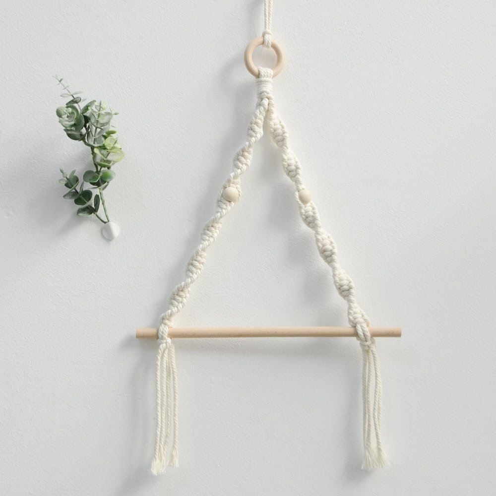 Round boho woven wall hanging on a natural wood frame