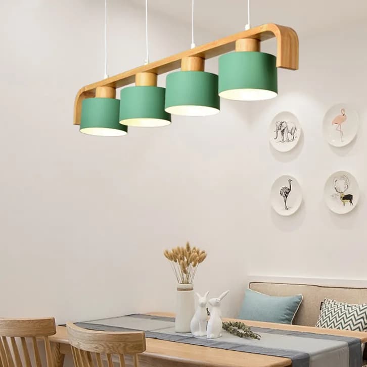 Hand-turned wood LED pendant light – green variant, shown in a room setting