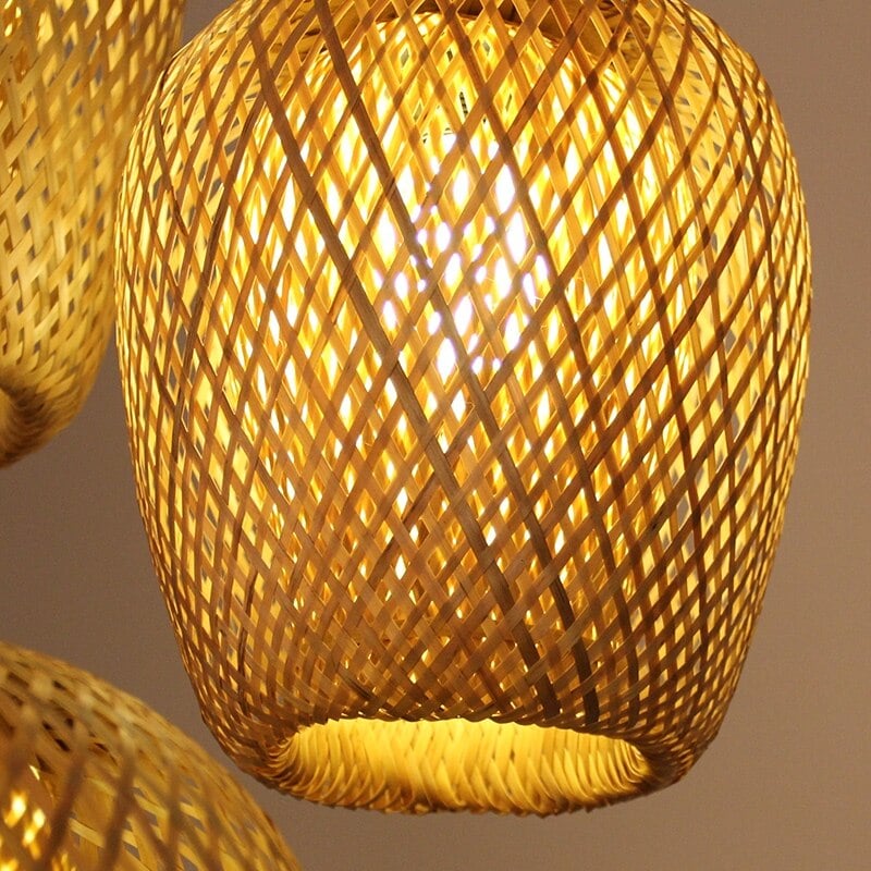 Three-shade handwoven rattan pendant light – close-up detail, lit
