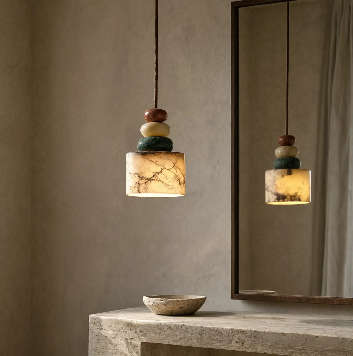 Agrigente stacked stone and marble pendant light – shown lit in a room setting