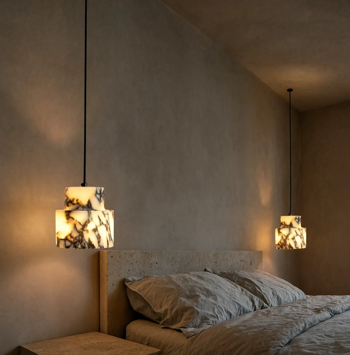 Héraclée two-tier white marble pendant light – shown in a bedroom
