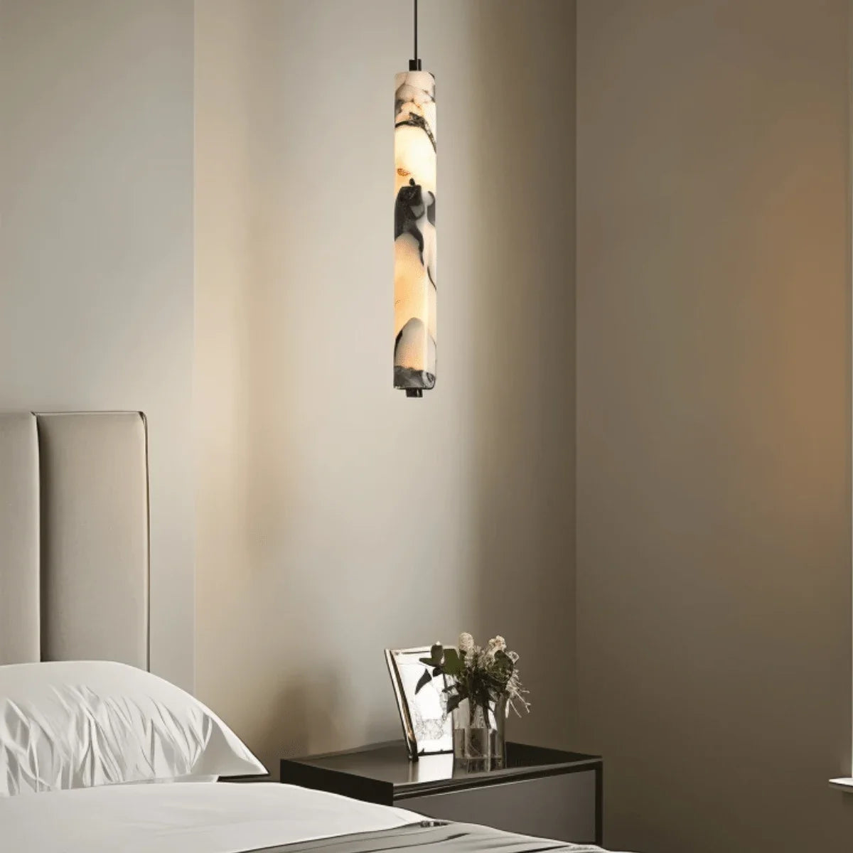 Sélinonte slim marble tube pendant light – shown in a bedroom (2)