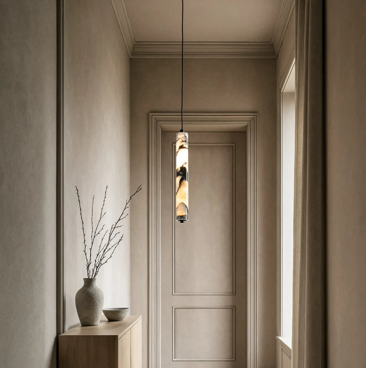 Sélinonte slim marble tube pendant light – shown in an entryway