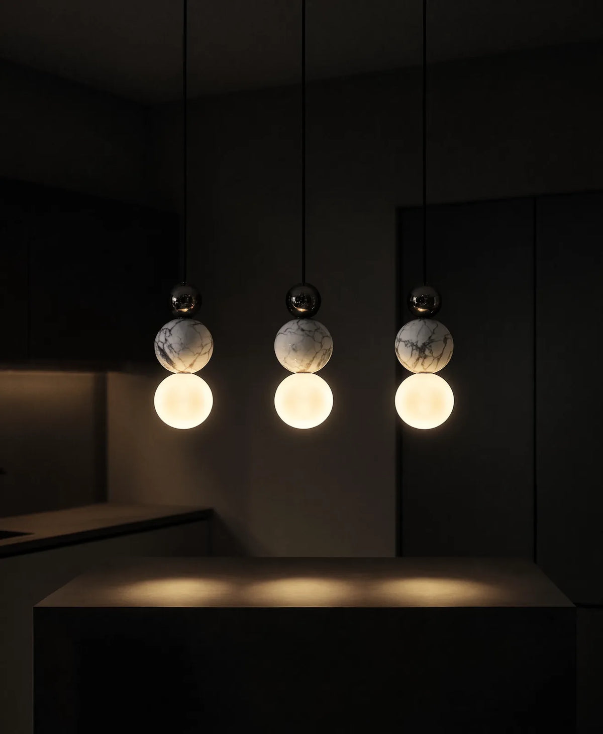 Locres marble and opal glass globe pendant light – shown lit in a kitchen
