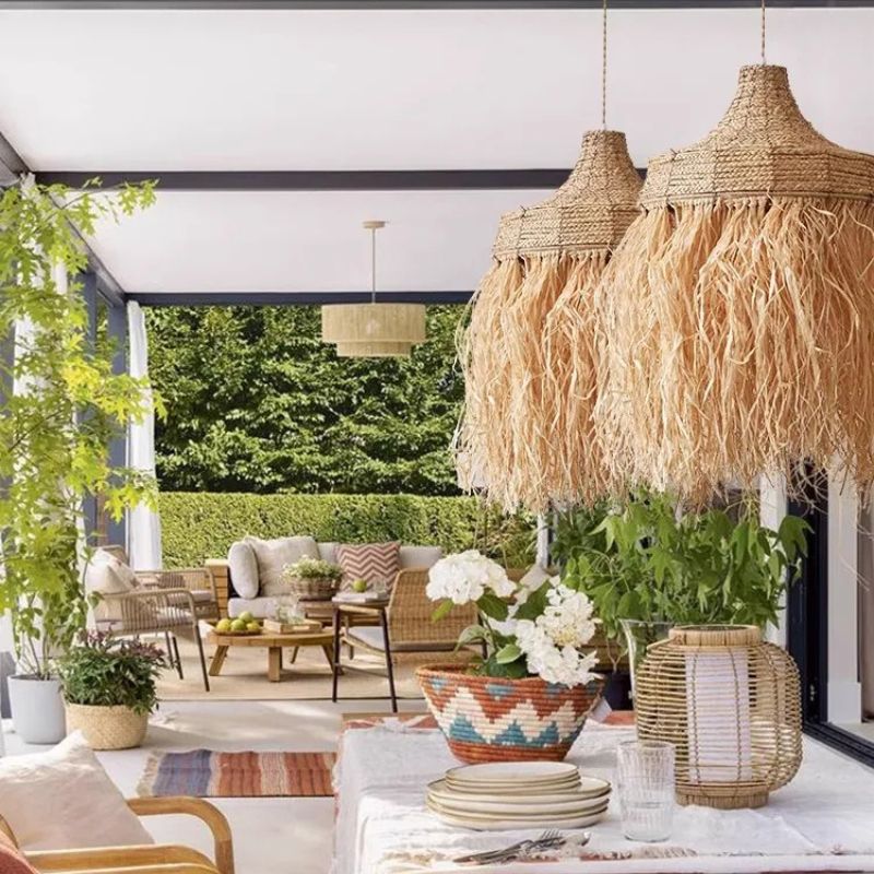 Handwoven textured straw pendant light with a rounded silhouette – shown in a room setting (3)