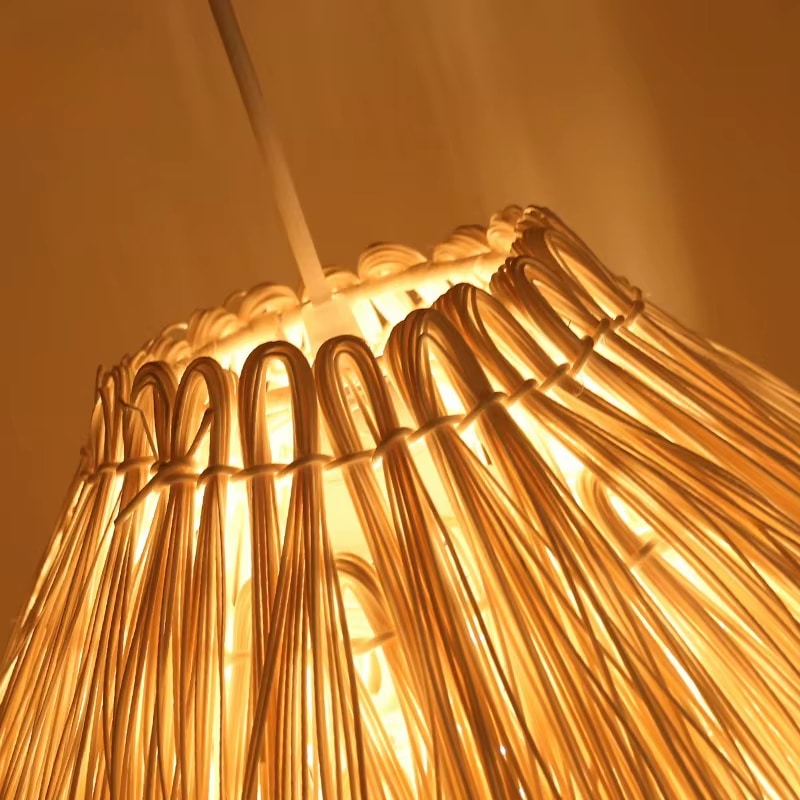 Modern geometric woven pendant light on an iron frame – close-up detail, lit