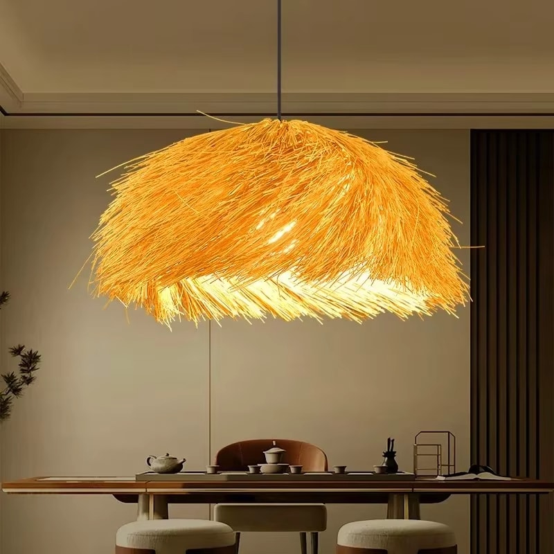 Round braided straw pendant light with a natural matte texture – shown lit