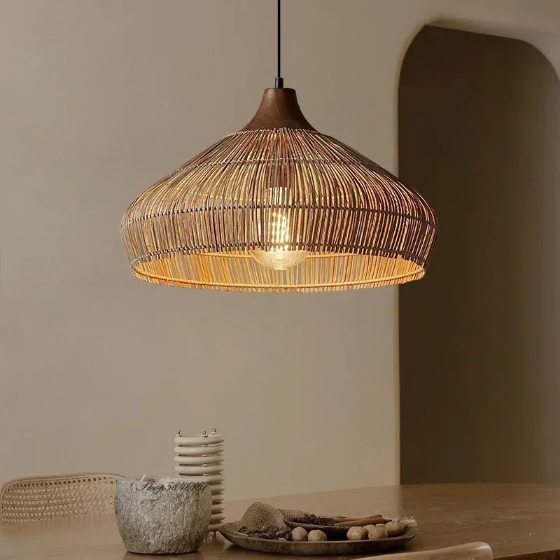 Adjustable-height handwoven rattan pendant light with open mesh – shown in a room setting