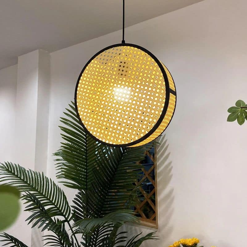 Modern openwork geometric rattan pendant light – shown in a room setting