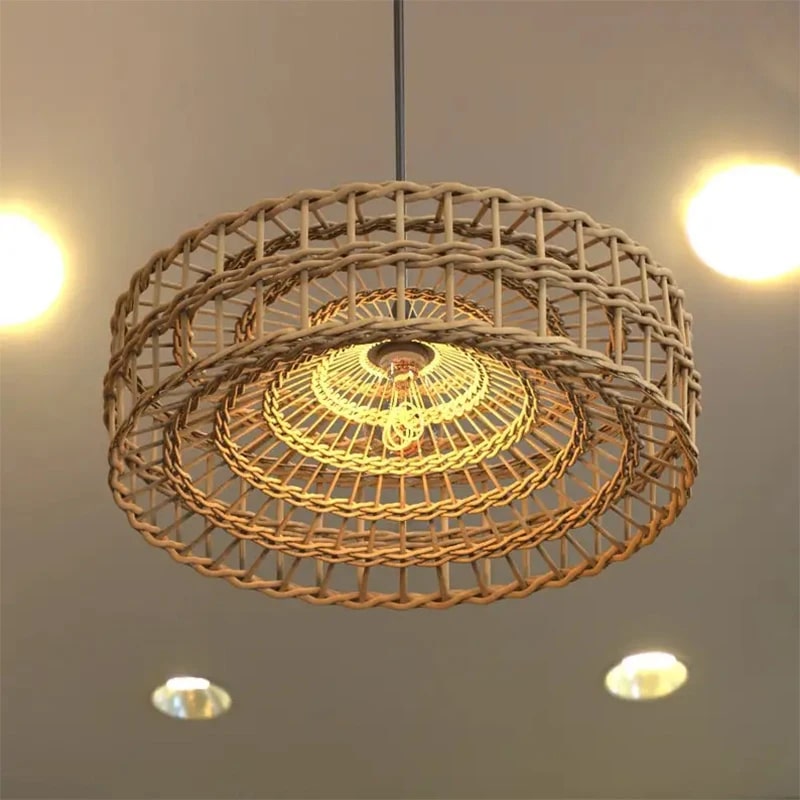 Modern egg-shaped handwoven rattan pendant light – close-up detail, lit
