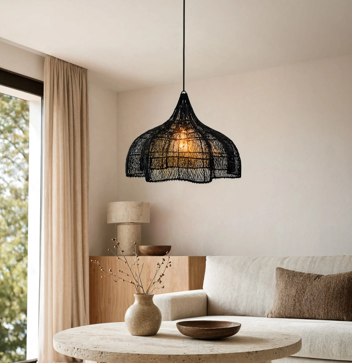 Taormine handwoven scalloped rattan pendant light – shown in a living room (3)