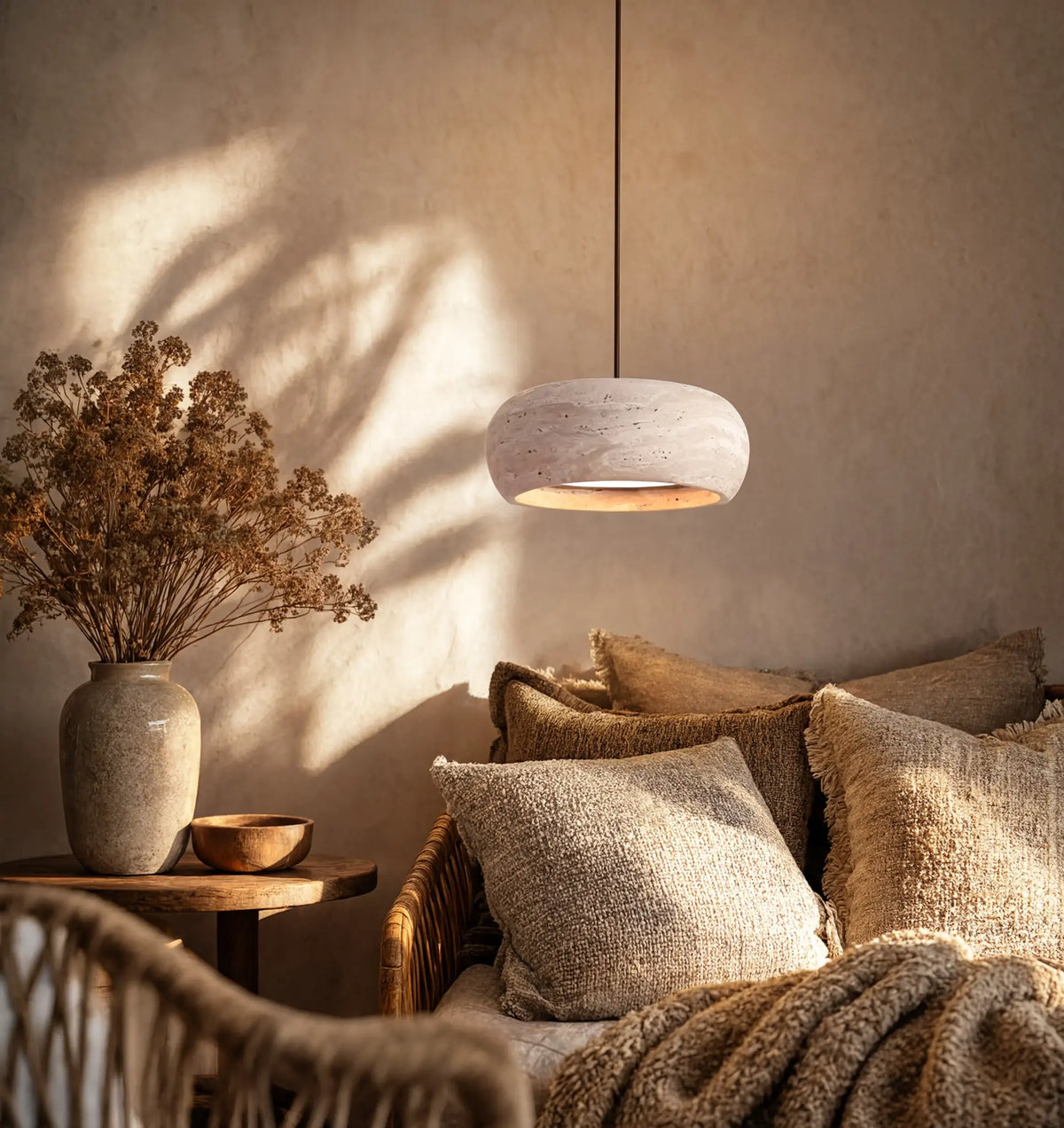 Claros travertine ring pendant light – shown in a living room