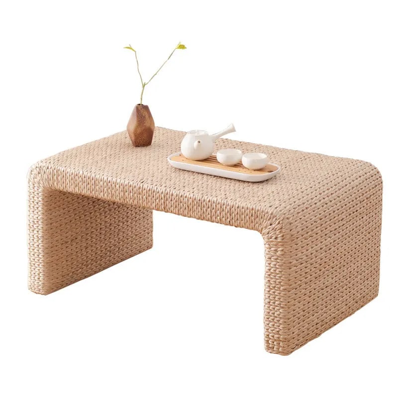 Japanese-style handwoven wicker coffee table with low curves – shown in a room setting