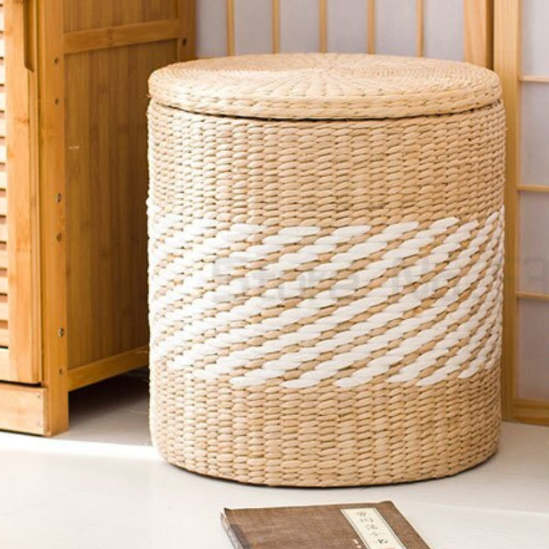 Round beige and white rattan storage stool with a lid – shown in a room setting