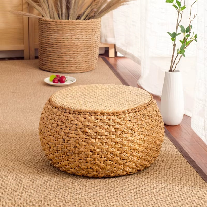 Minimalist round wicker stool with a tightly woven seat – shown in a room setting