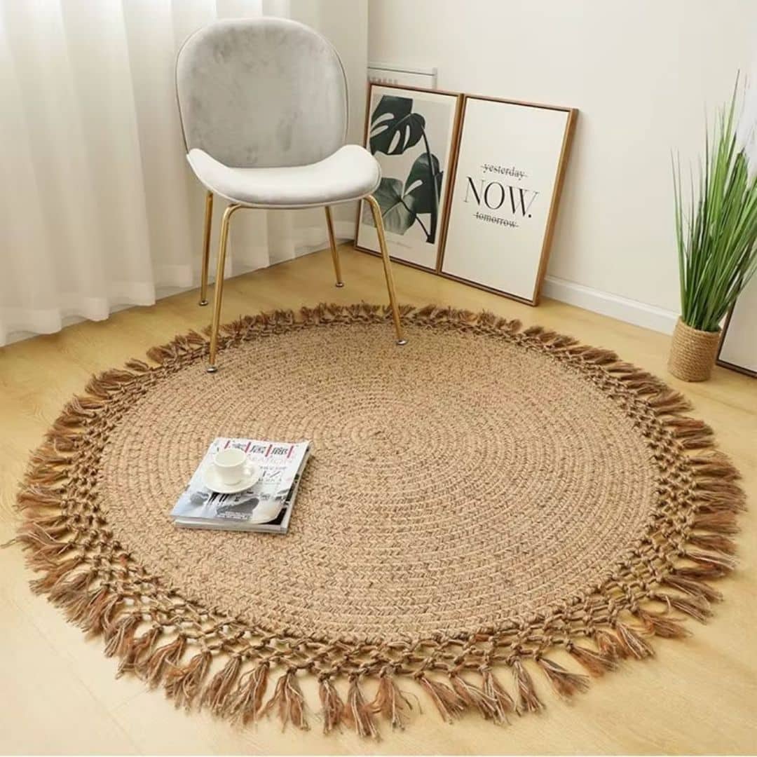 Retro round braided jute rug with tassels – shown in a room setting