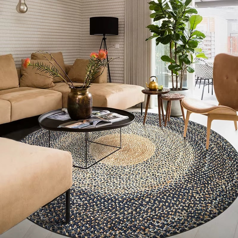 Round bamboo fiber rug with three concentric circles in black, gray and beige – shown in a room setting