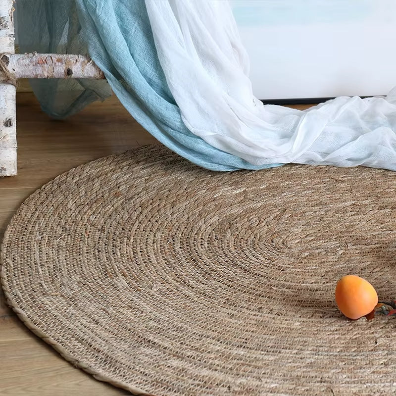 Oval handwoven genuine wicker rug in warm beige – shown in a room setting (2)