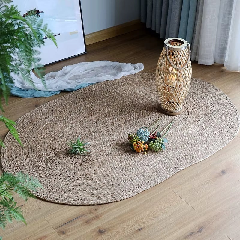Oval handwoven genuine wicker rug in warm beige – shown in a room setting (3)