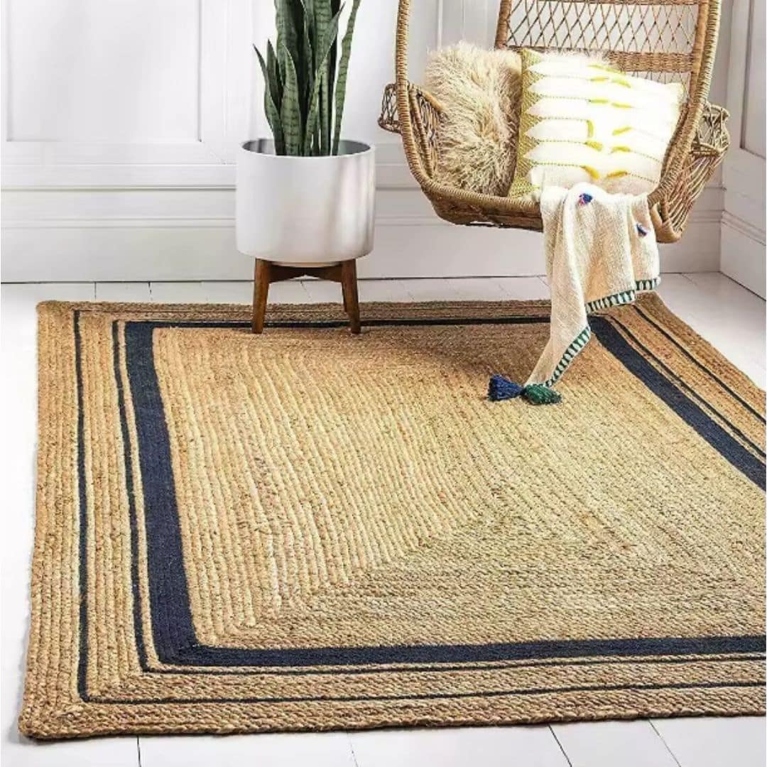 Rustic rectangular wicker rug with dark edging – shown in a room setting (2)