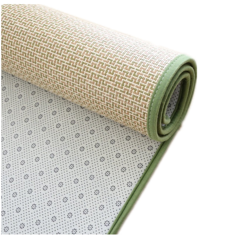 Rectangular synthetic rattan rug with a green border