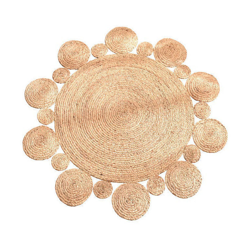 Round rattan rug with a scalloped edge of raised circles