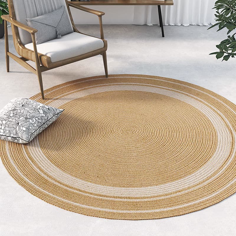 Round natural jute rug with a golden tone – shown in a room setting
