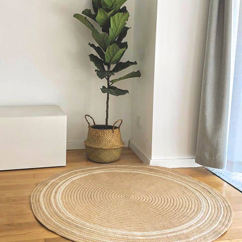 Round natural jute rug with a golden tone – shown in a room setting (3)