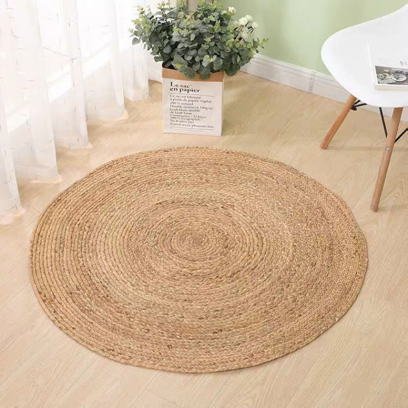 Round light honey rattan rug with a relief texture – shown in a room setting (2)