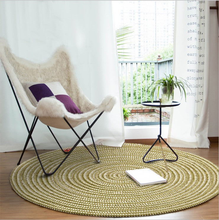 Round green and cream synthetic rattan rug – shown in a room setting (2)