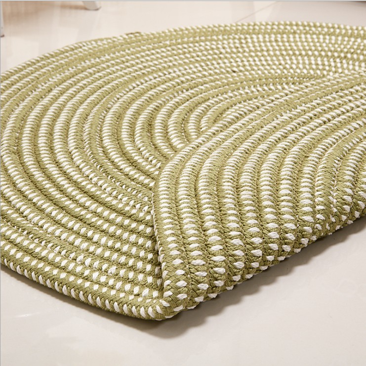 Round green and cream synthetic rattan rug – close-up detail