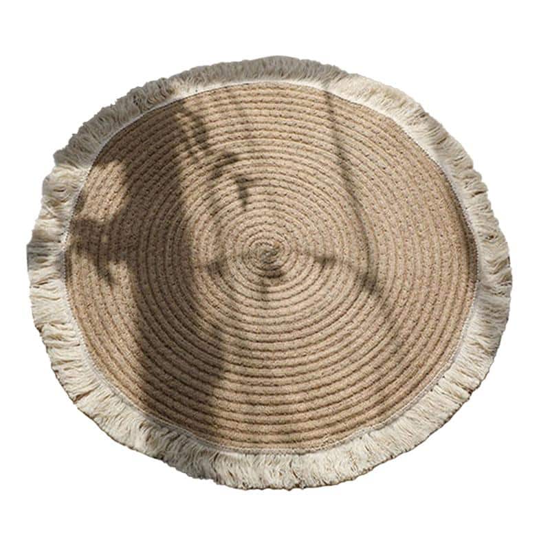 Round handmade cotton and linen rug with a pom-pom fringe