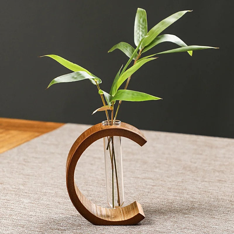 C-shaped bamboo vase with a clear glass tube – shown in a room setting