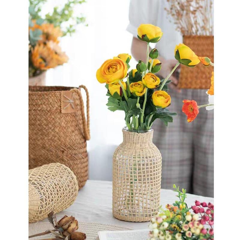 Clear glass vase wrapped in a woven square-pattern sleeve – shown in a room setting