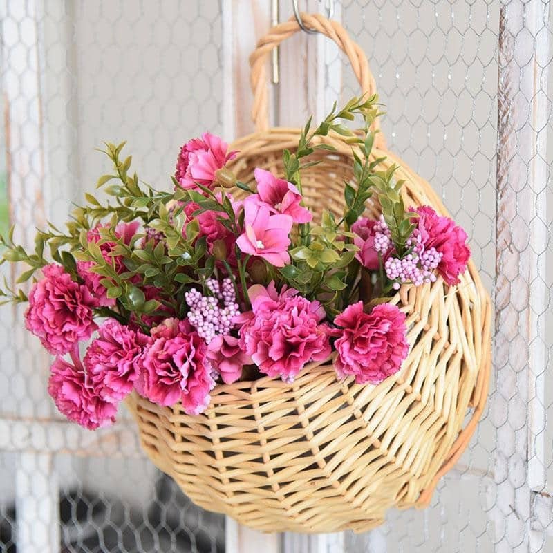 Round hanging rattan wall vase with golden highlights – shown in a room setting (2)