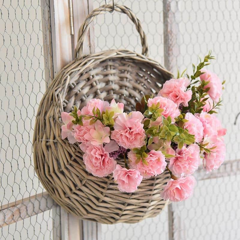 Round hanging rattan wall vase with golden highlights – shown in a room setting (3)