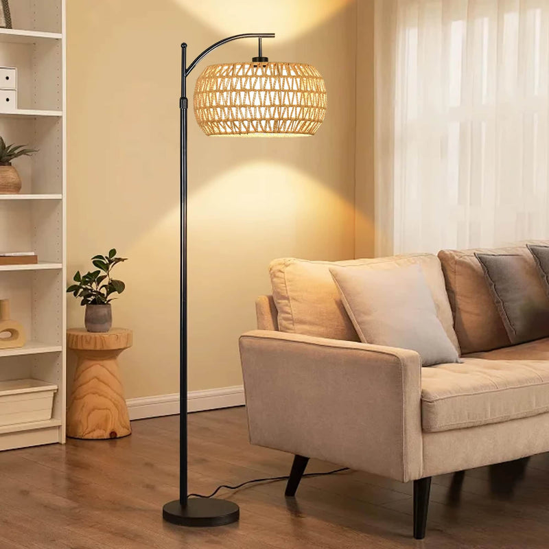 Bohemian rattan floor lamp with a hand-braided shade – shown lit in a room setting